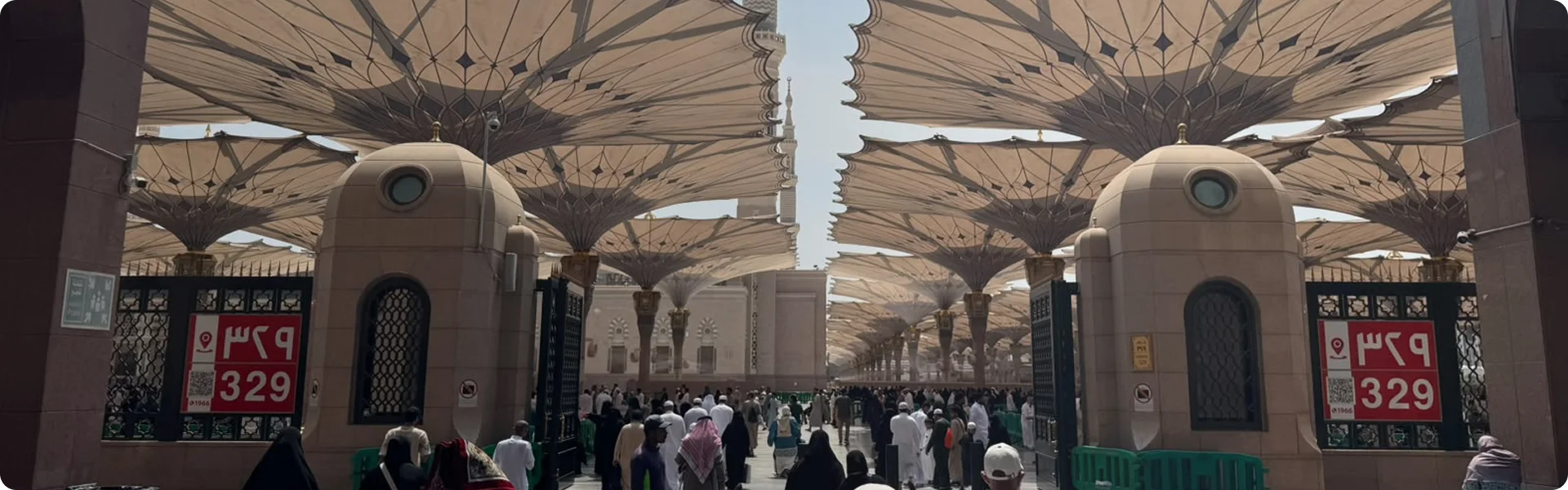Warm stone street near Furni at golden hour, the dome of Al Masjid Al Nabawi visible in the distance